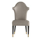 Gray chair with black legs and gold accents on a white background
