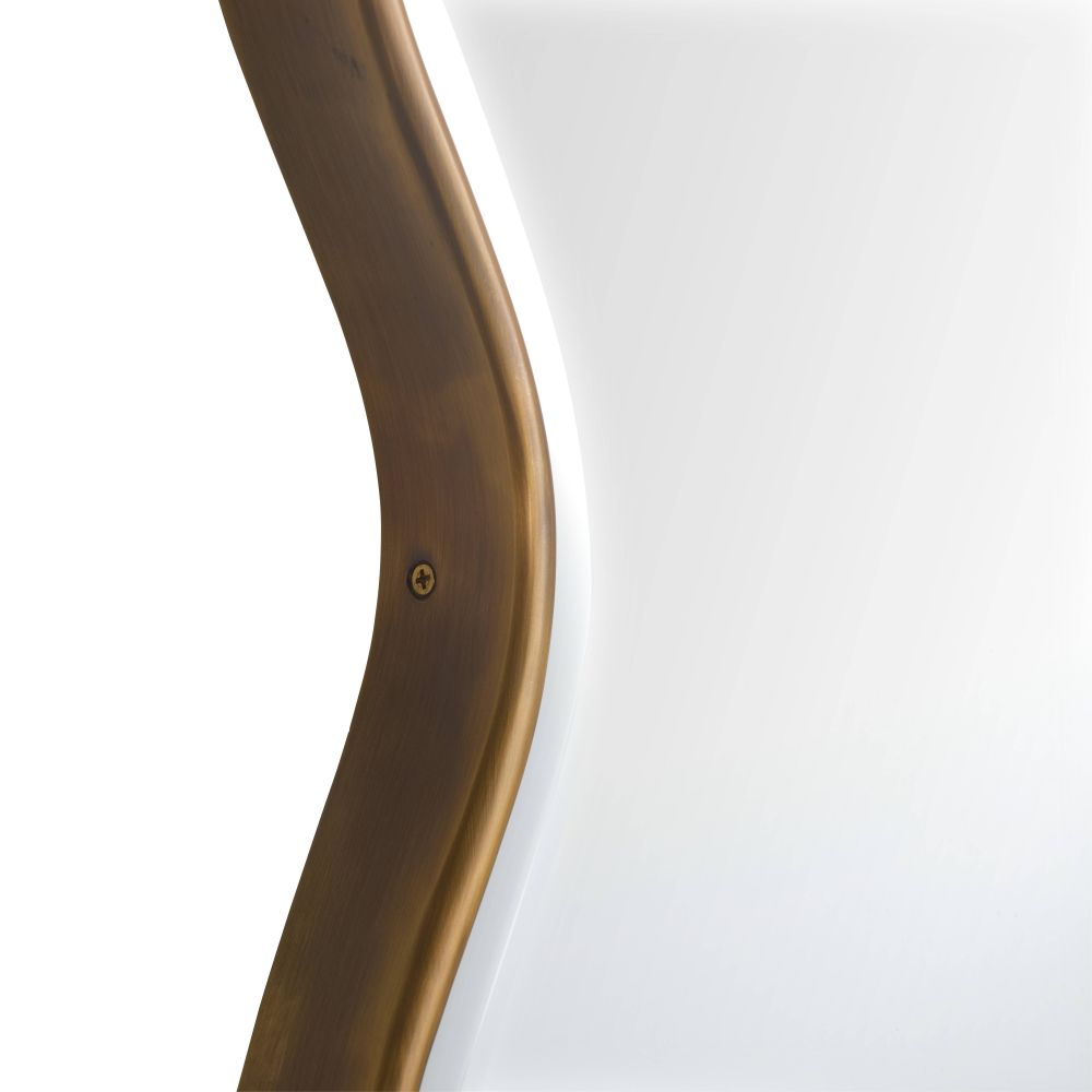 Close-up of a curved bronze metal object on a white background