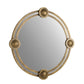 Round mirror with decorative gold frame on a white background