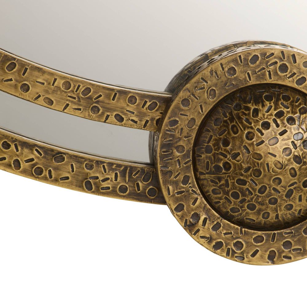 Decorative bronze mirror with intricate patterns on a white background