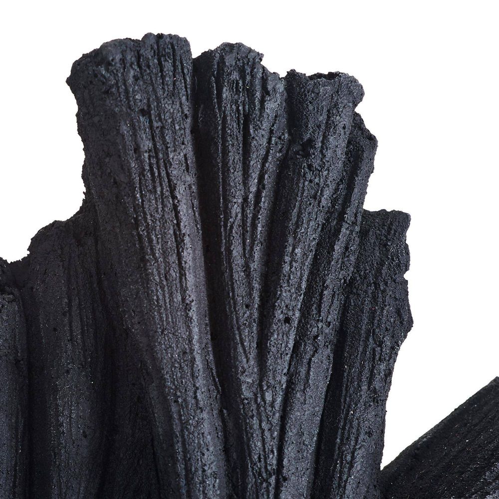 Close-up of dark gray, textured material resembling wood or stone on a white background