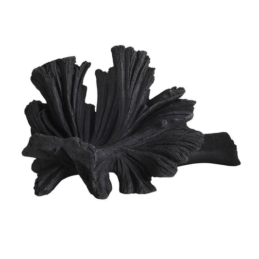 Black decorative leaf-like object on a white background