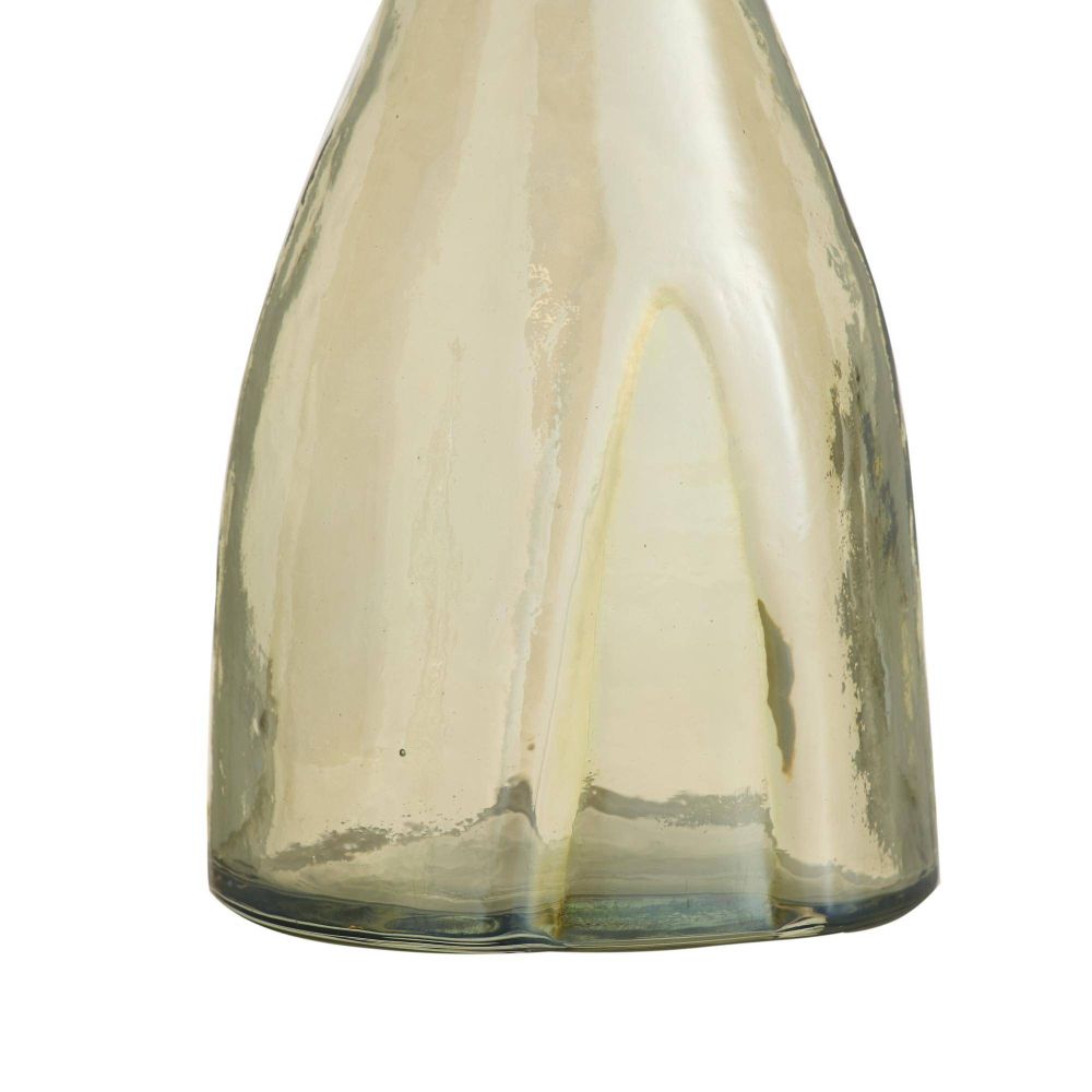 Clear glass bottle with a white candle inside on a white background