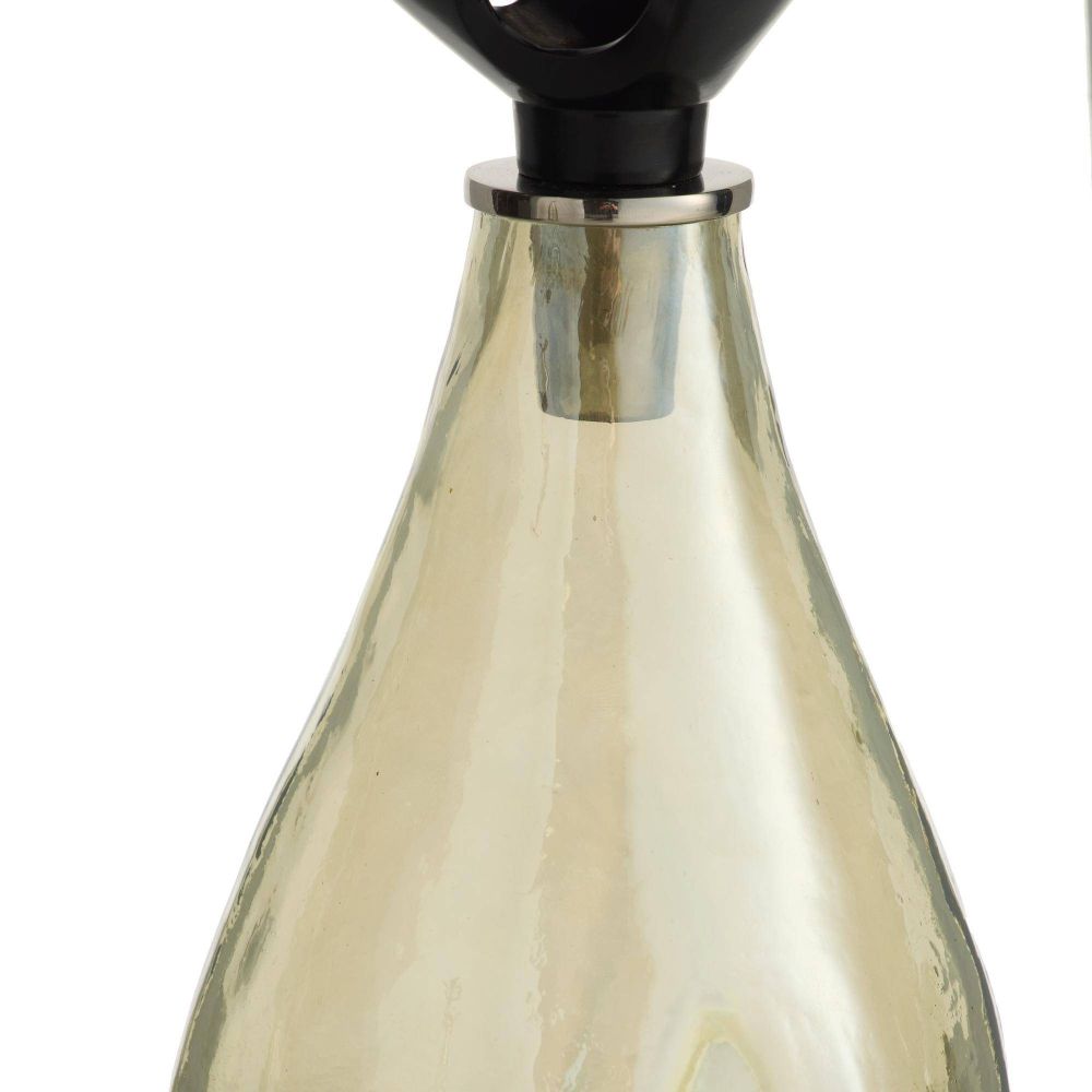 Glass bottle with a metallic cap on a white background