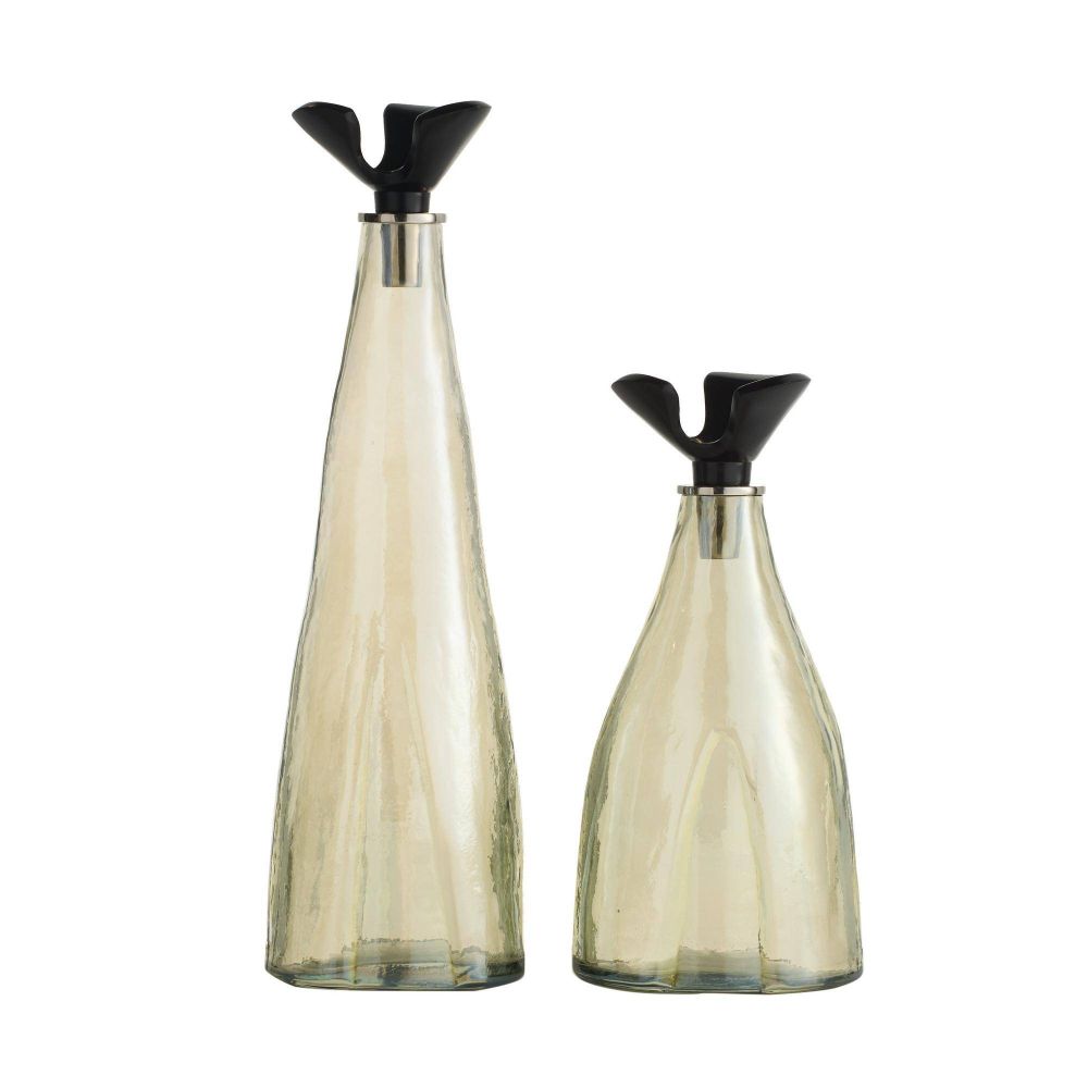 Two glass bottles with black lids on a white background