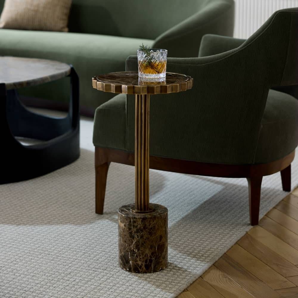 Small round wooden table with drinks in a living room setting
