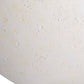 Close-up of a textured white surface with small specks