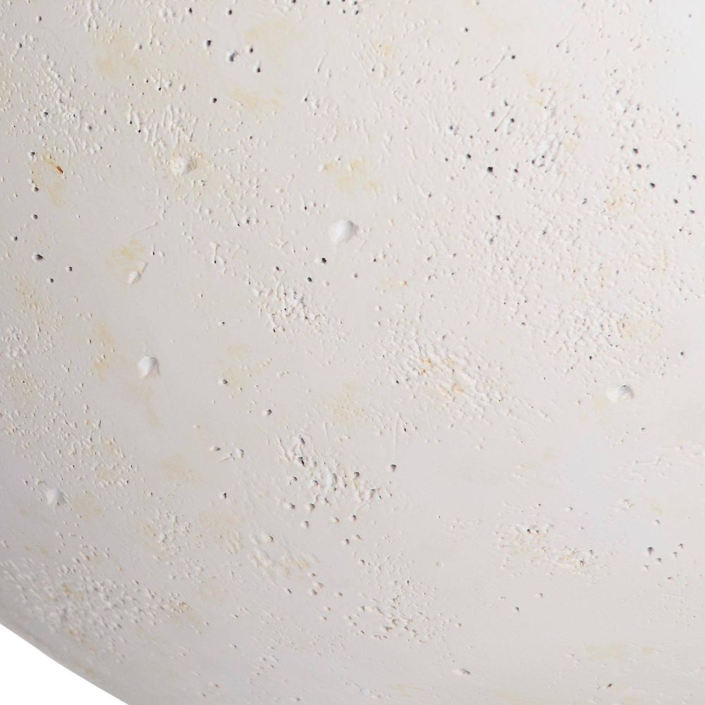 Close-up of a textured white surface with small specks