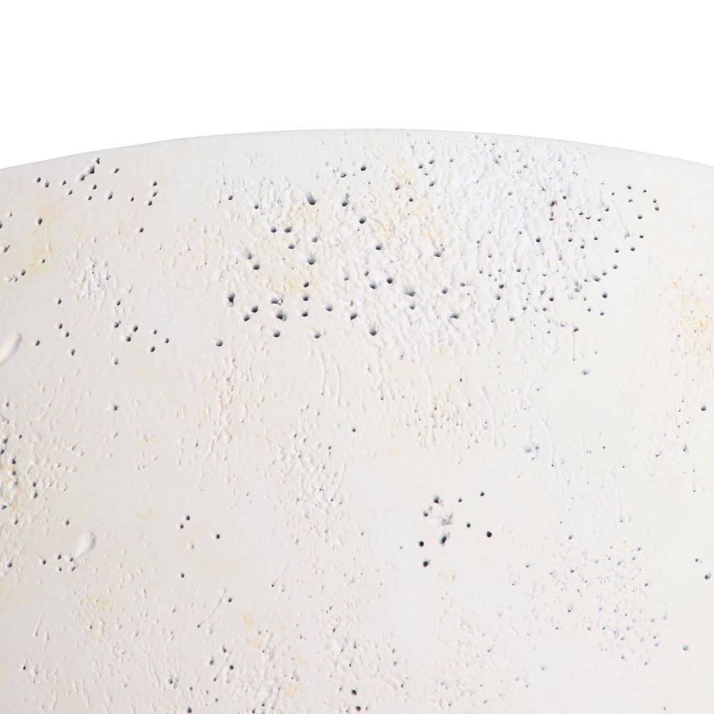 Close-up of a textured white surface with small black specks