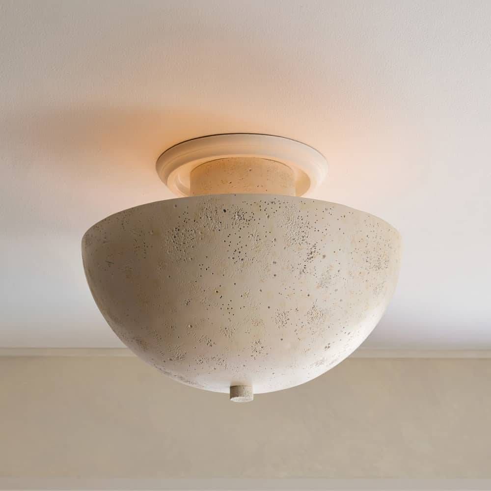 Ceiling light fixture with textured beige shade on a neutral ceiling.