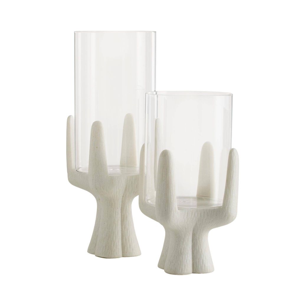 Two glass candle holders with white wooden-like bases on a white background