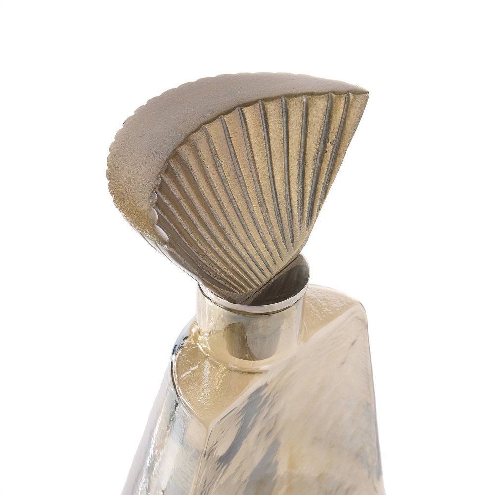 Decorative bottle with shell-shaped cap on a white background