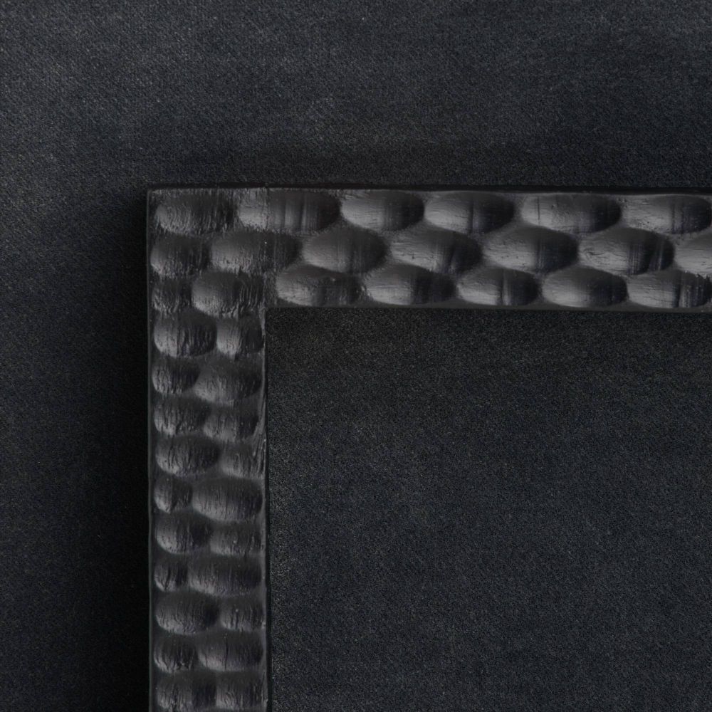 Black dining chair with cushioned seat and backrest on a white background