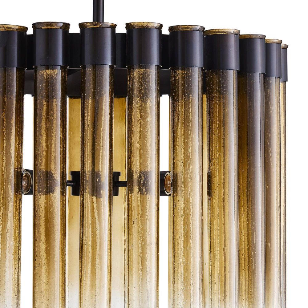 Close-up of a modern pendant light fixture with cylindrical glass shades.