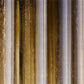 Close-up of a textured material with vertical stripes in brown, beige, and gray.