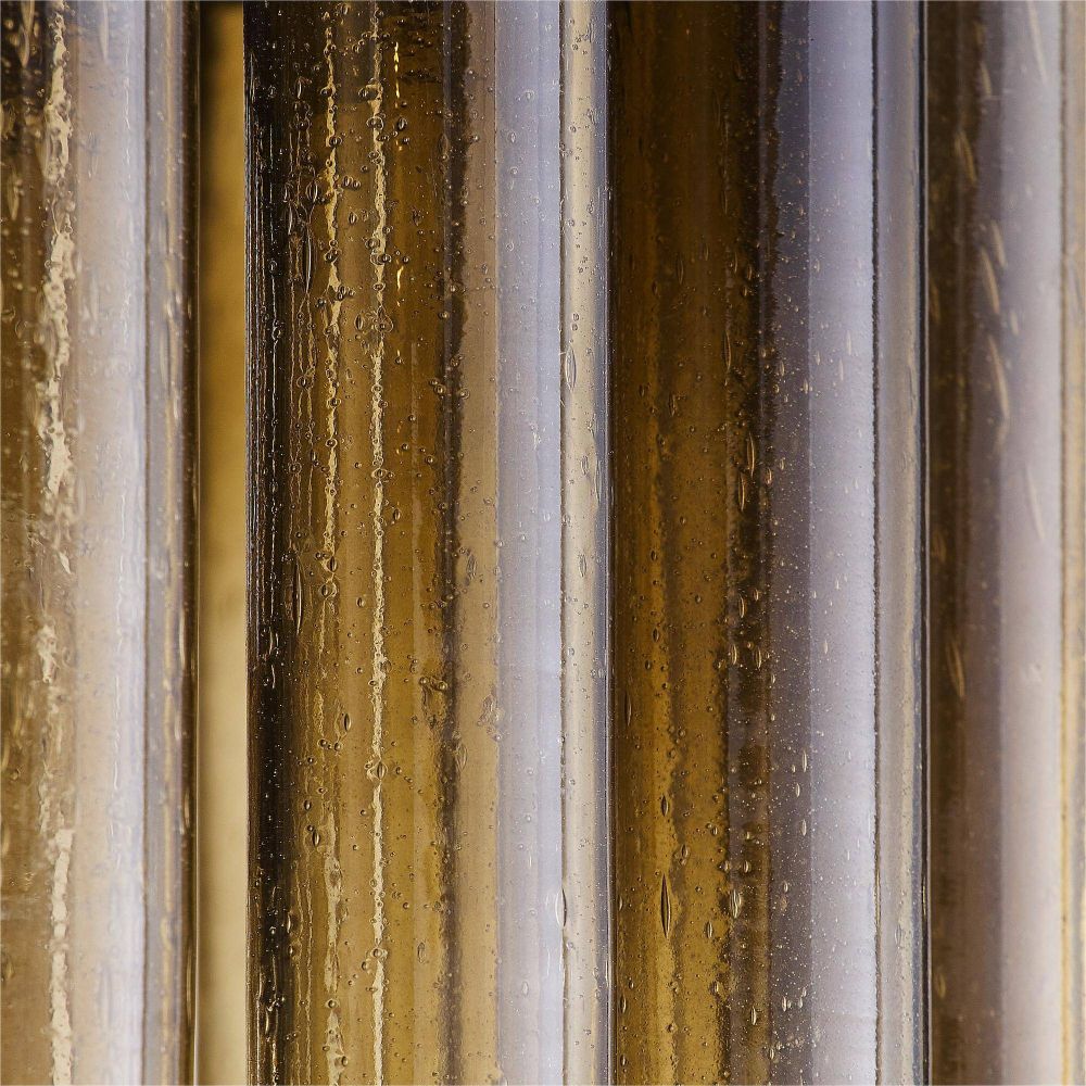 Close-up of a textured material with vertical stripes in brown, beige, and gray.