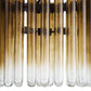 Close-up of a decorative wall light fixture with glass tubes.