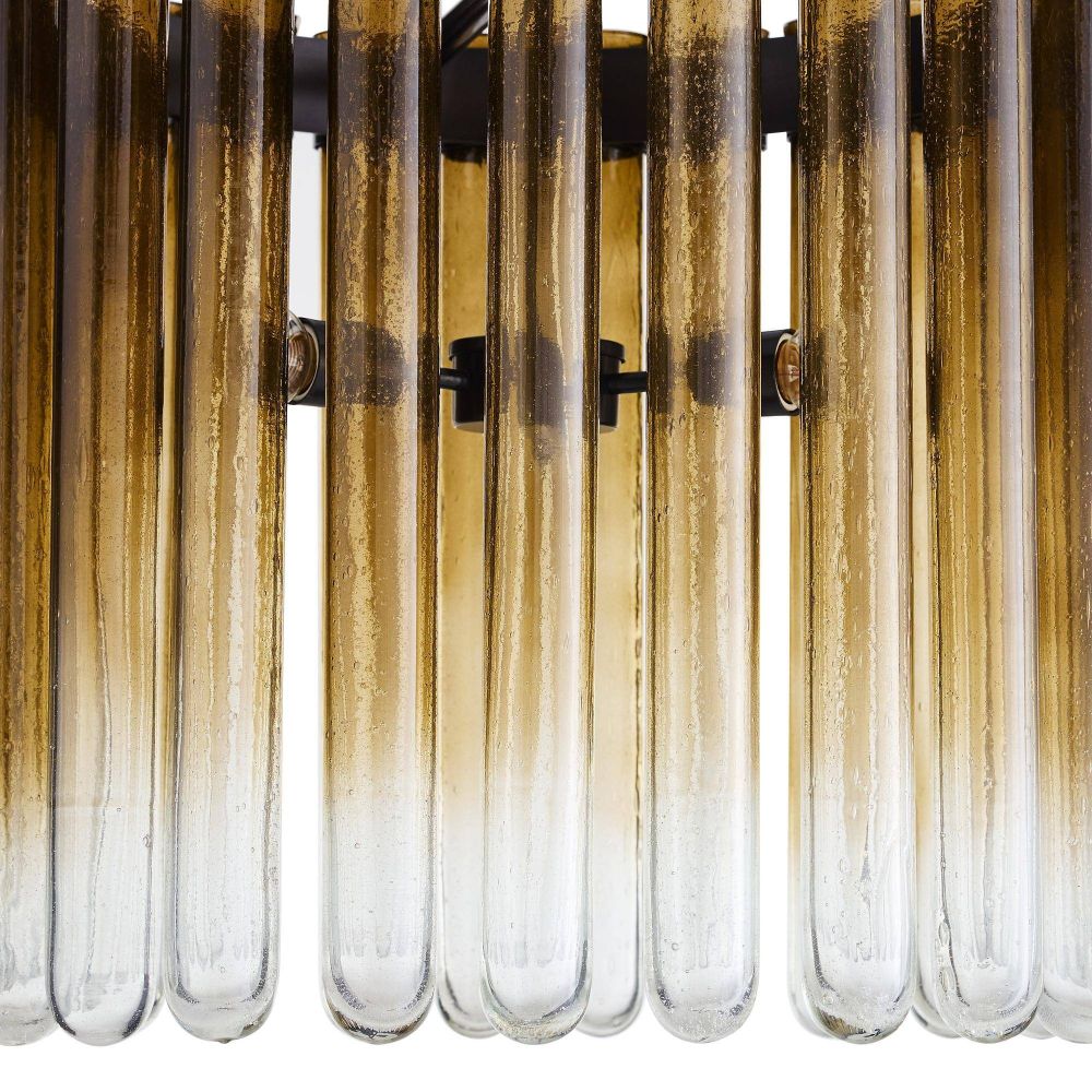 Close-up of a decorative wall light fixture with glass tubes.