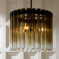 Modern chandelier with glass tubes against a neutral background