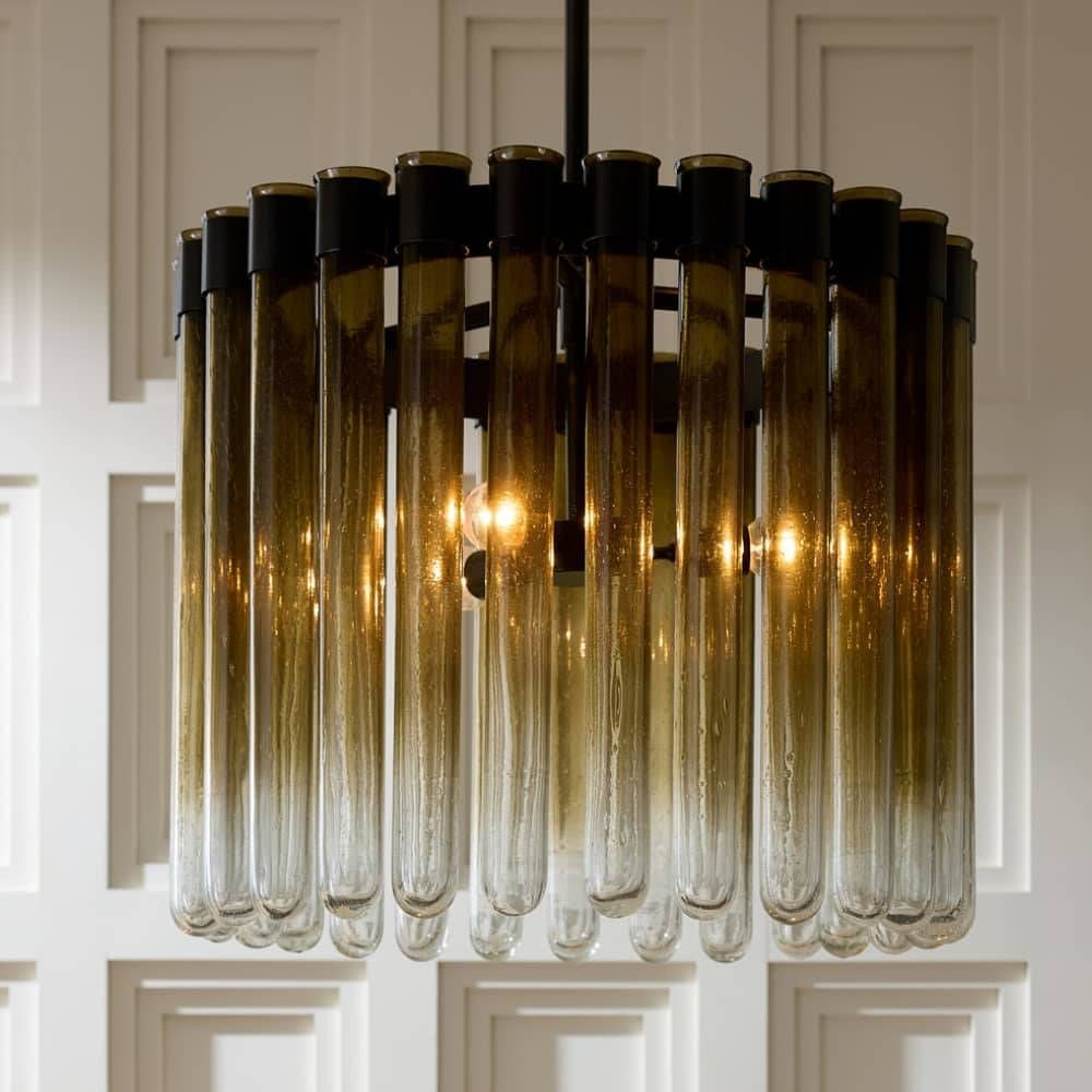 Modern chandelier with glass tubes against a neutral background