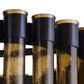 Close-up of three cylindrical glass objects with black metal bases on a white background