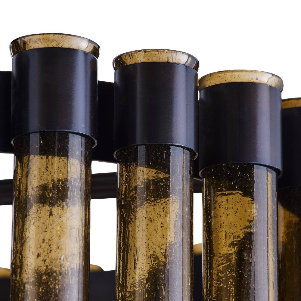 Close-up of three cylindrical glass objects with black metal bases on a white background