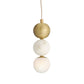 Pendant light with gold and white spherical shades on a white background