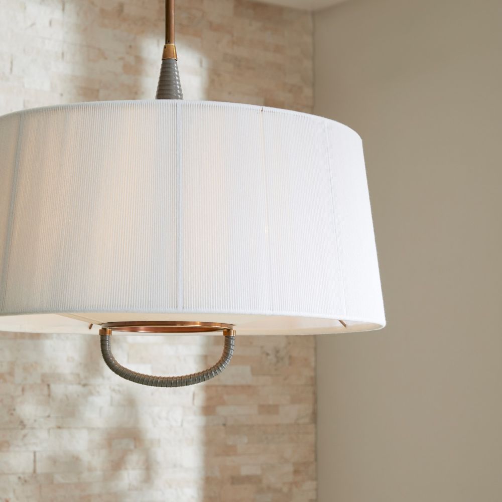 White pendant light with bronze fixture against a neutral wall.