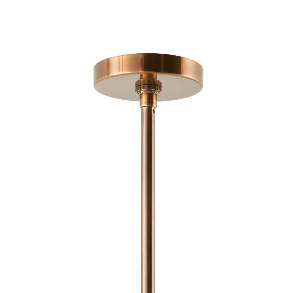 Copper pendant light fixture on a white background