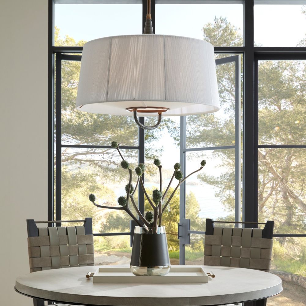 Dining room with a round table, chairs, and a large window.