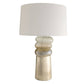 Table lamp with a textured base and white shade on a white background