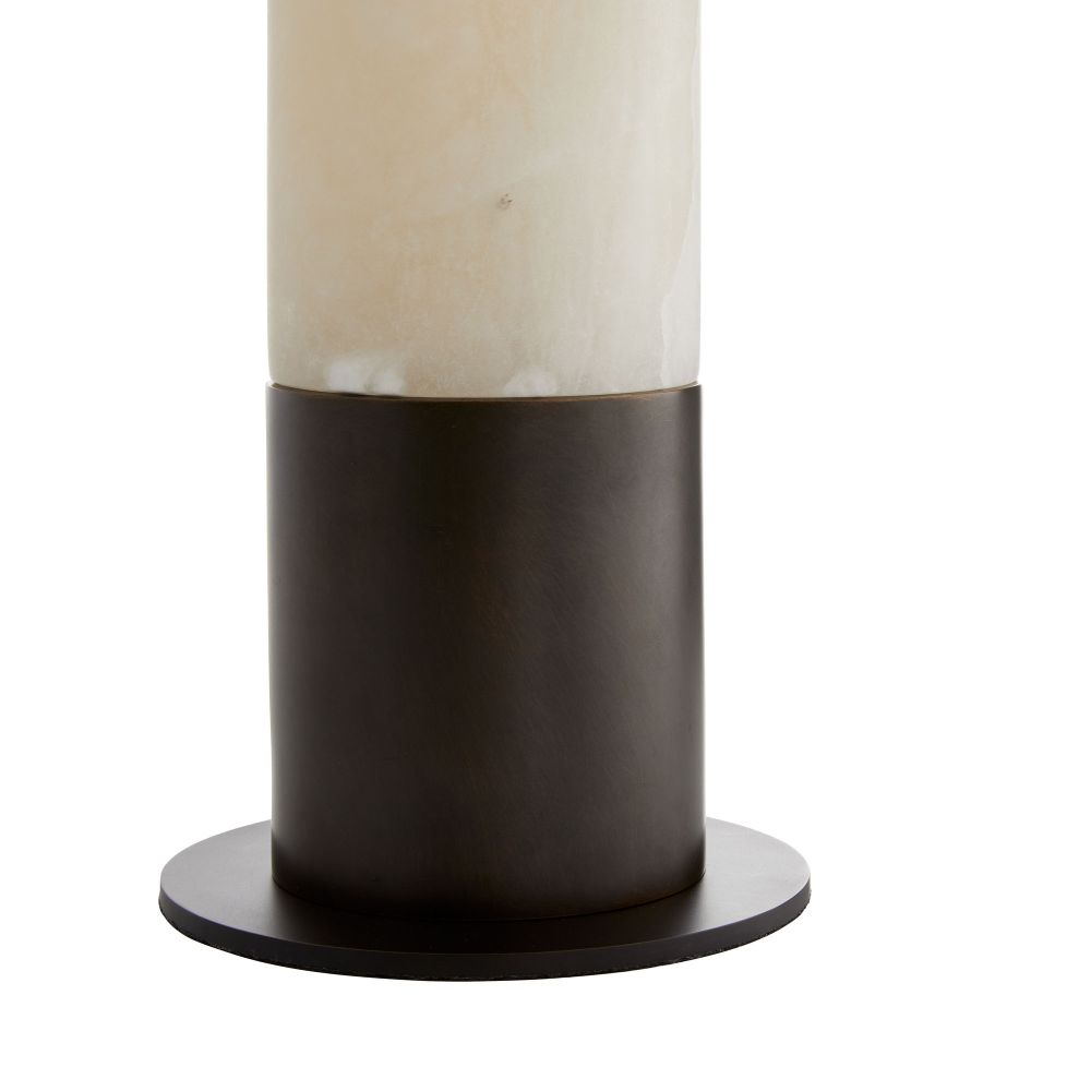 Cylindrical lamp with a beige glass shade and black base on a white background