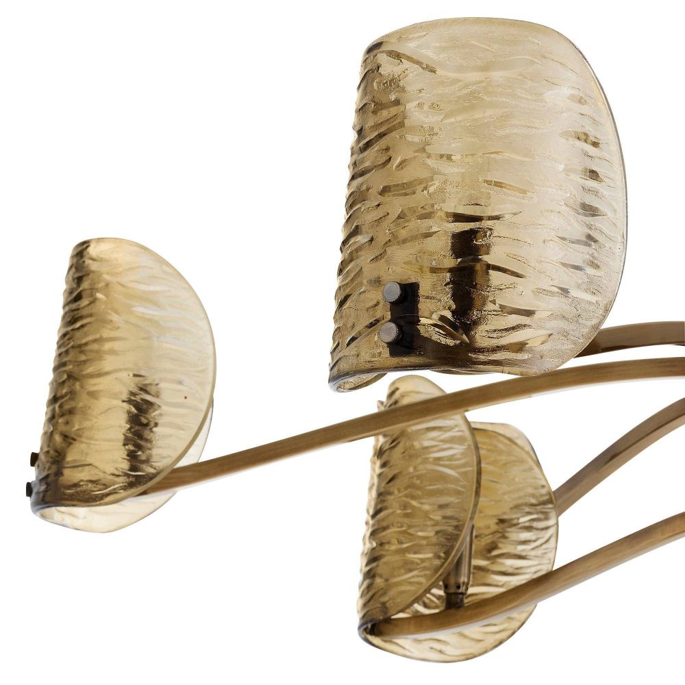 Decorative wall sconce with three amber glass shades on a white background
