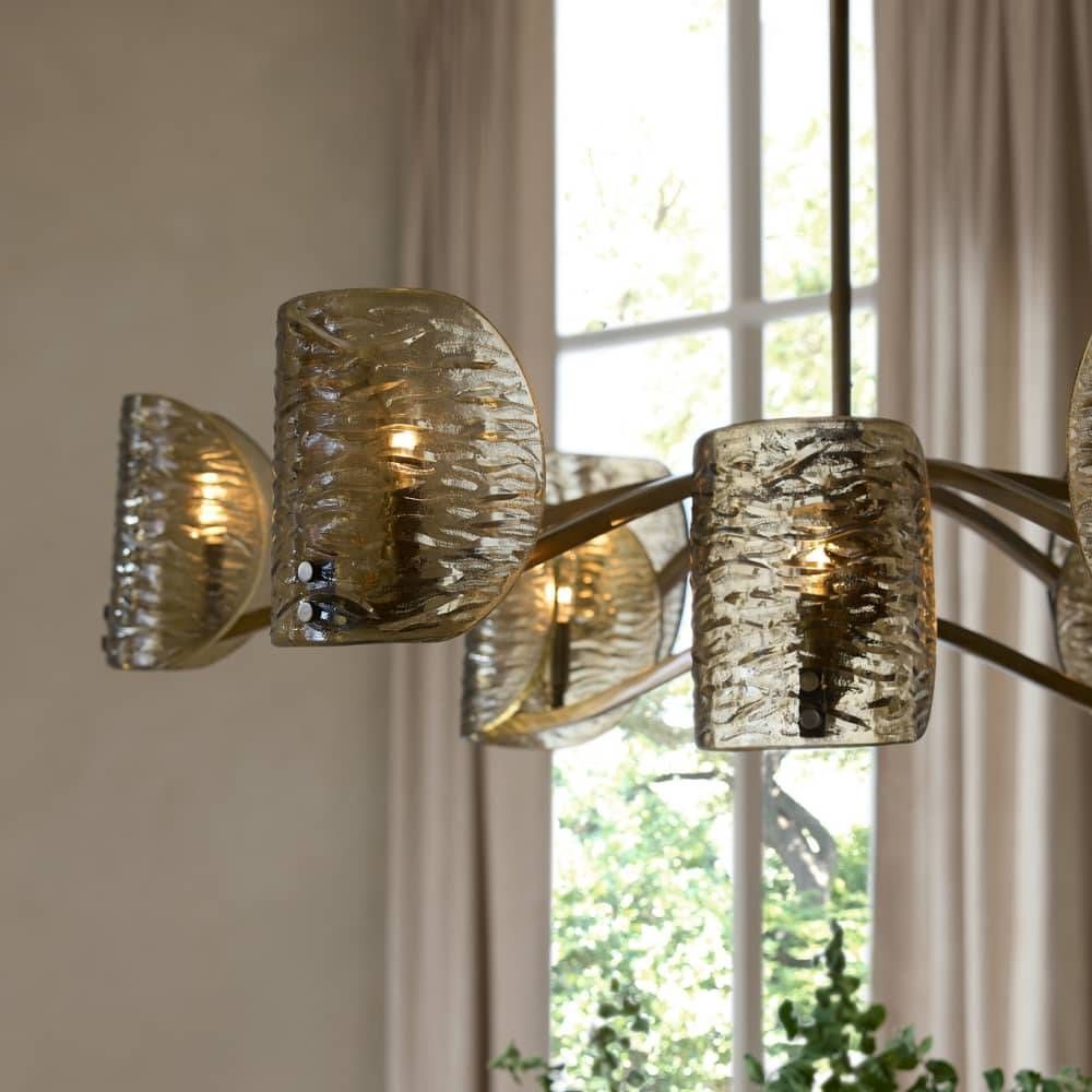 Chandelier with textured glass shades in a room with a window and plants.
