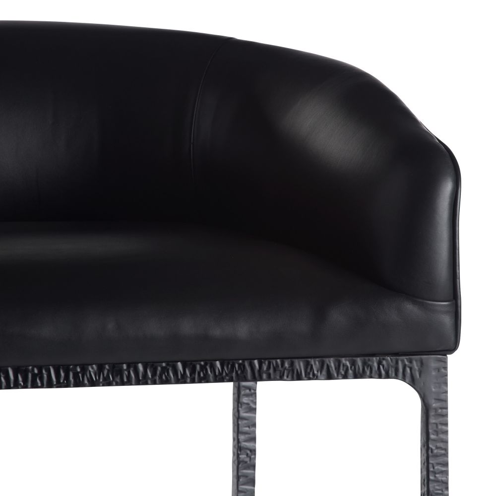Close-up of a black leather chair with a textured metal frame on a white background