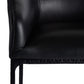 Close-up of a black leather chair corner on a white background