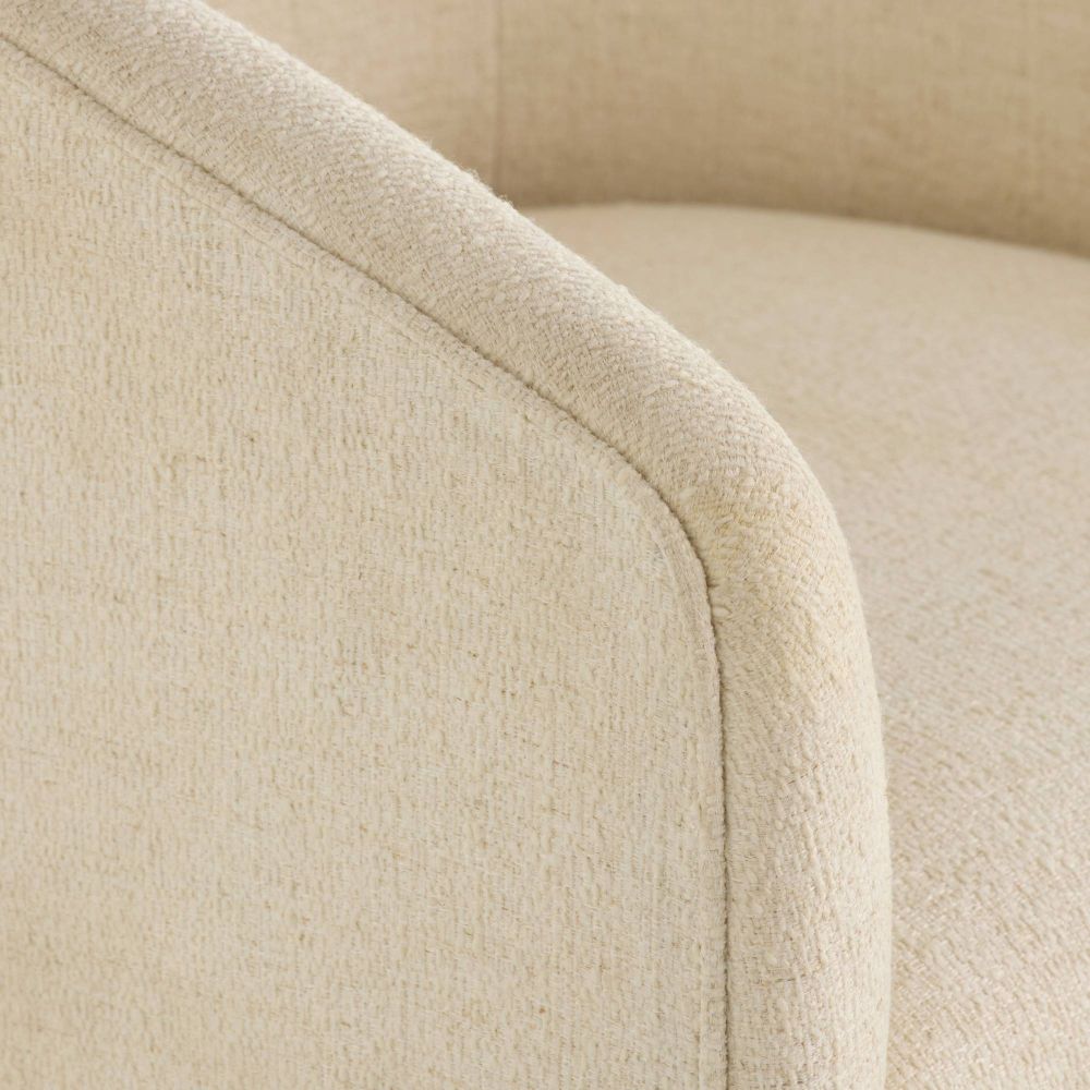 Close-up of a beige upholstered chair with a soft texture.