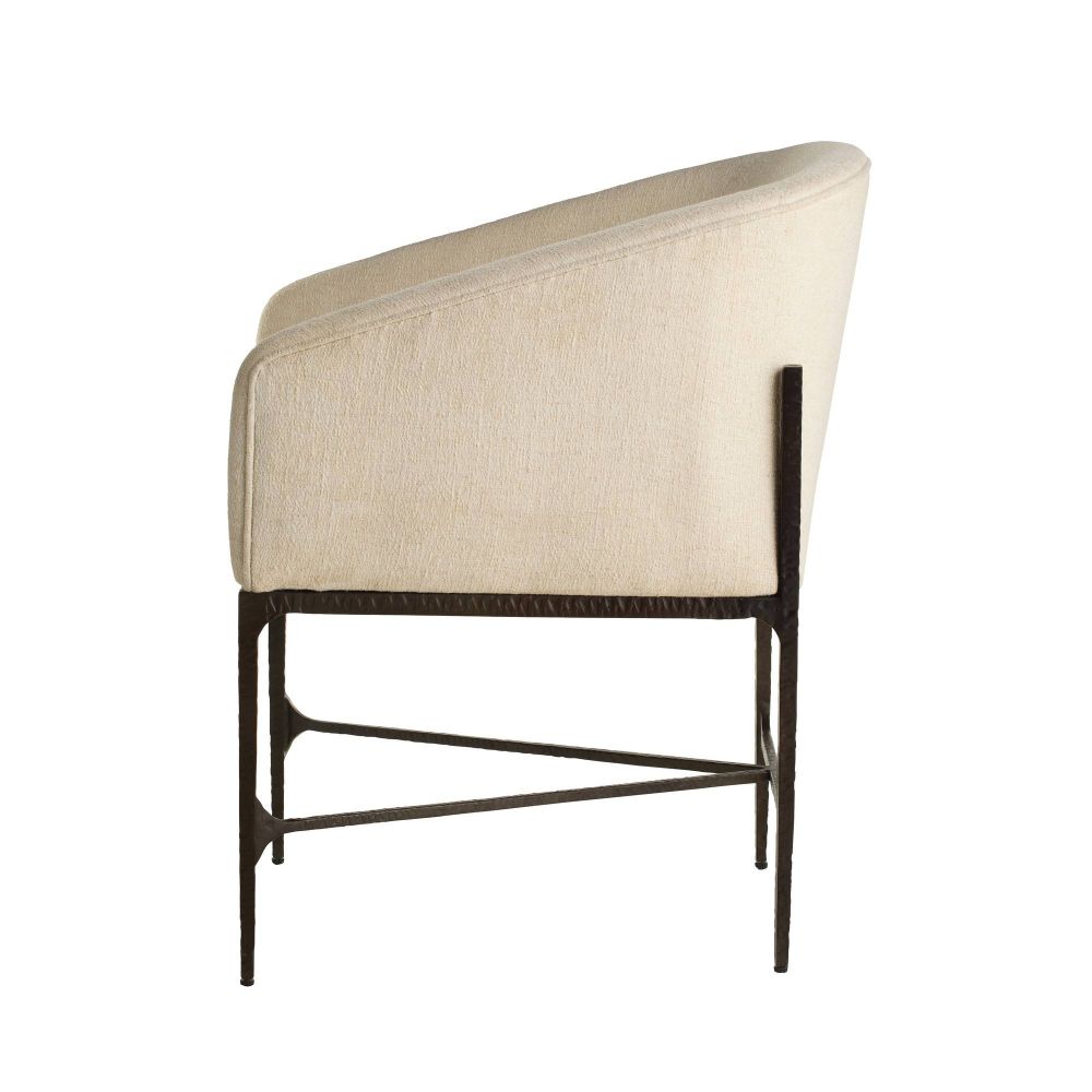 Beige upholstered chair with dark metal frame on a white background