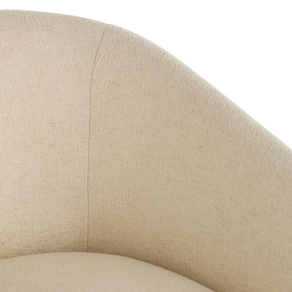 Close-up of a beige upholstered chair armrest on a white background
