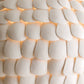 Close-up of a textured white surface with a warm light accent