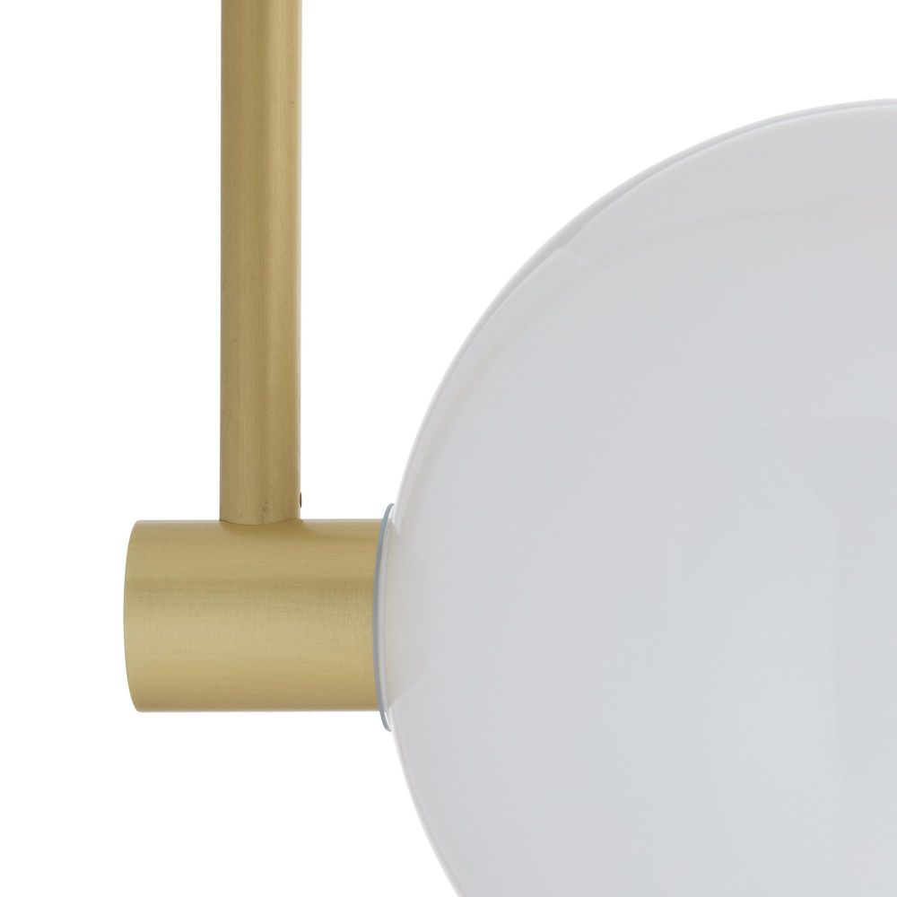 Close-up of a gold cylindrical object with a white spherical object on a white background