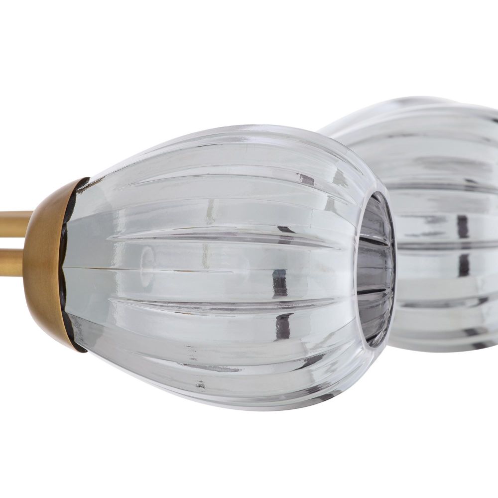 Close-up of a glass light fixture with gold accents on a white background