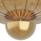 Close-up of a gold decorative wall piece with a scalloped edge.