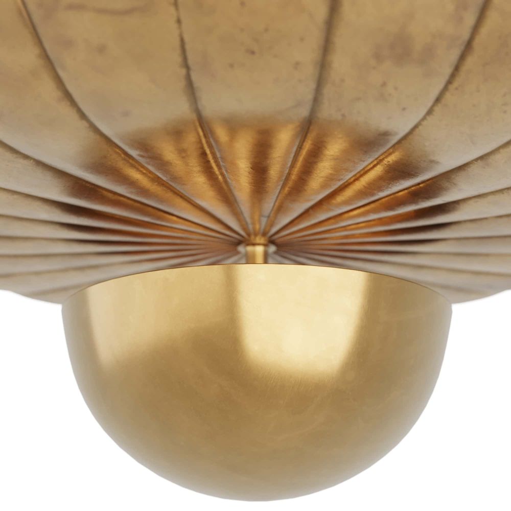 Close-up of a gold decorative wall piece with a scalloped edge.