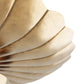 Close-up of a gold bracelet with concentric circular design on a white background