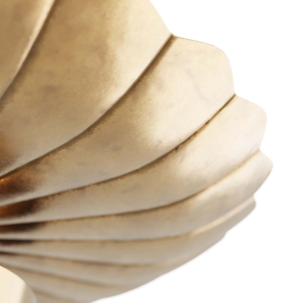 Close-up of a gold bracelet with concentric circular design on a white background