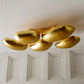 Gold ceiling light fixture on a white wall