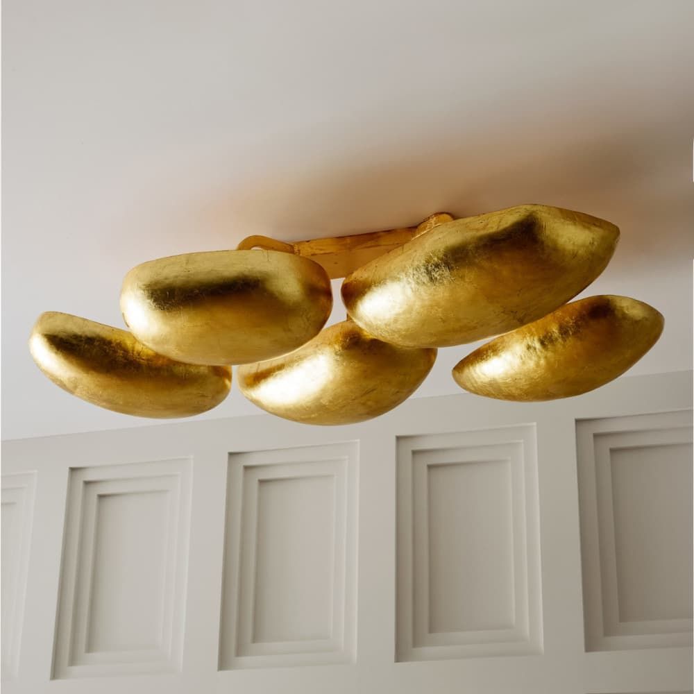 Gold ceiling light fixture on a white wall