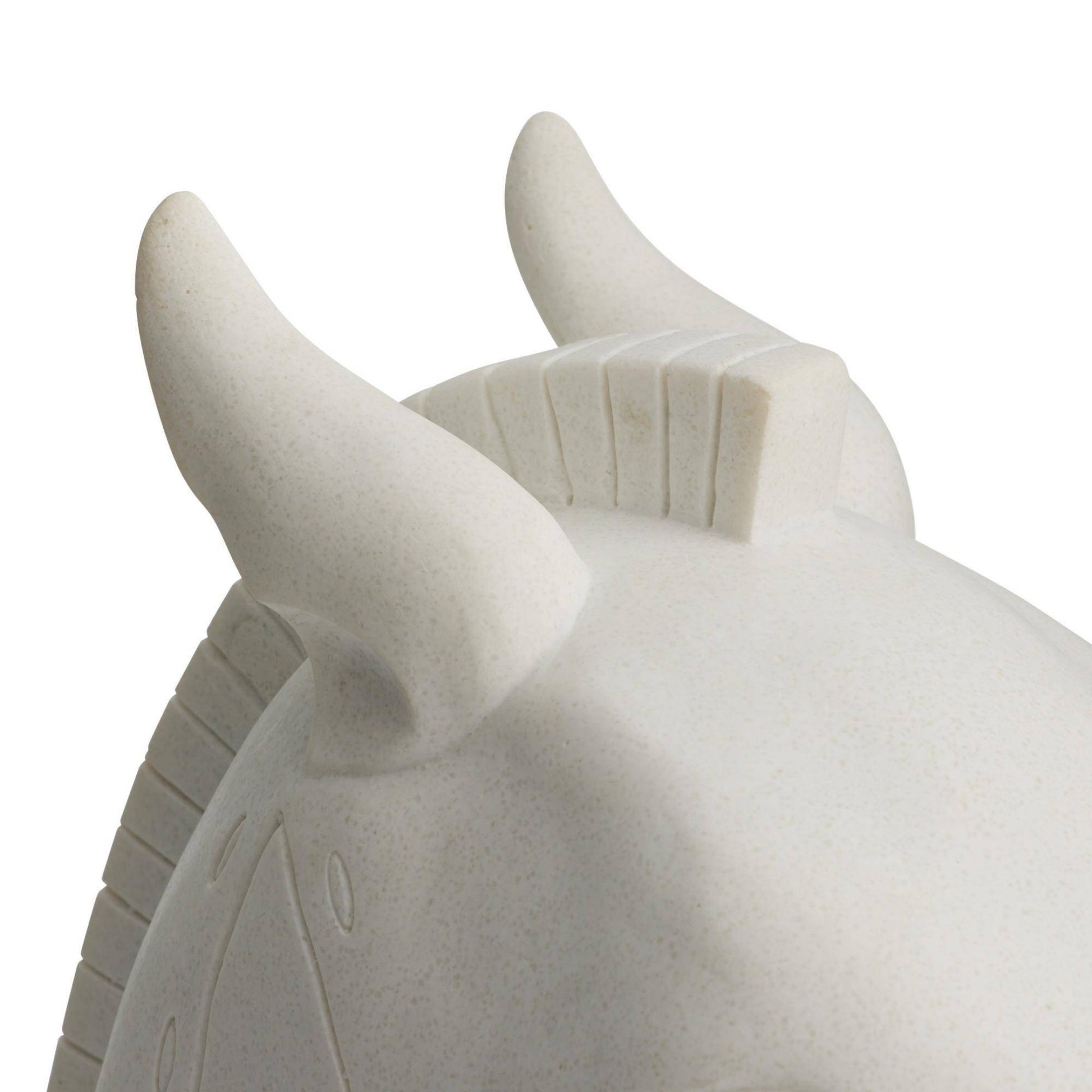 Close-up of a stone bull sculpture on a white background