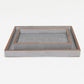 Decorative tray with textured surface and wooden frame on a white background